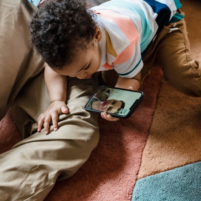 parent using smartphone with child