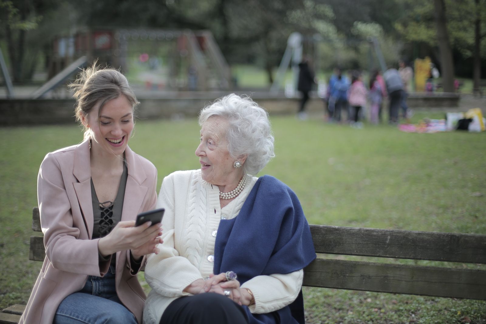 Two women having a calm conversation on a park bench