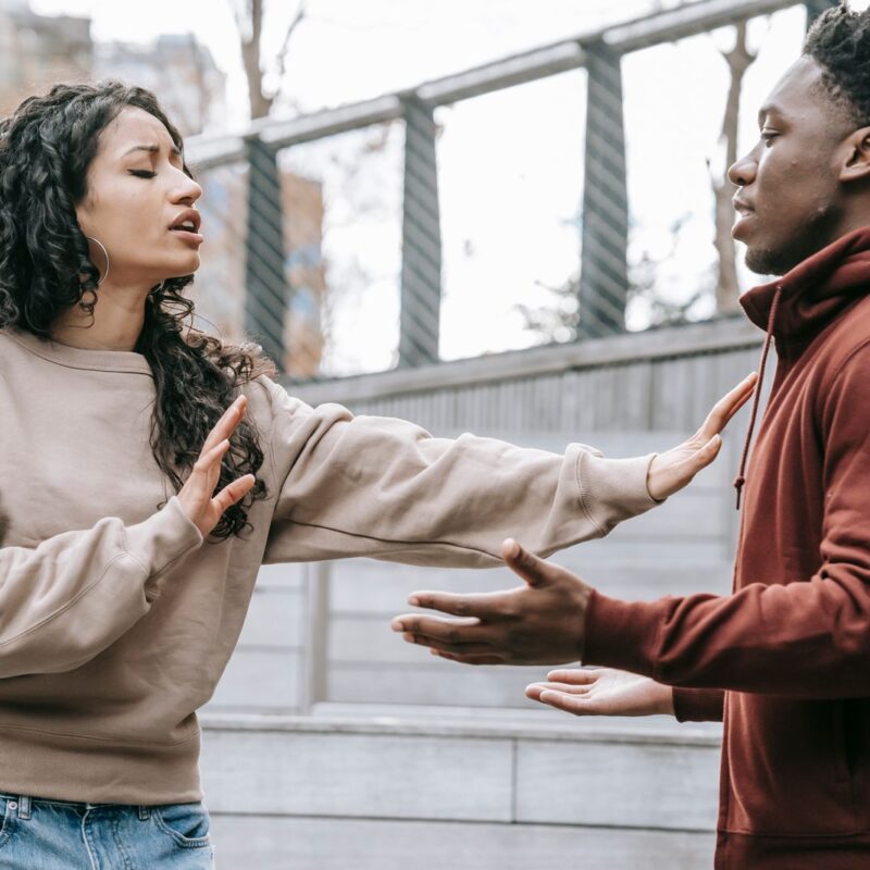 A couple having a difficult conversation outdoors