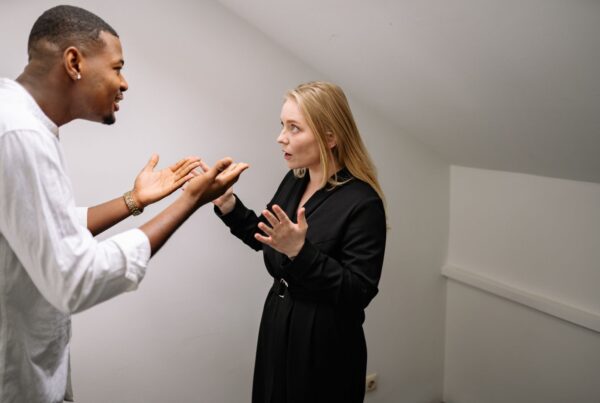 A man and woman having a heated discussion indoors