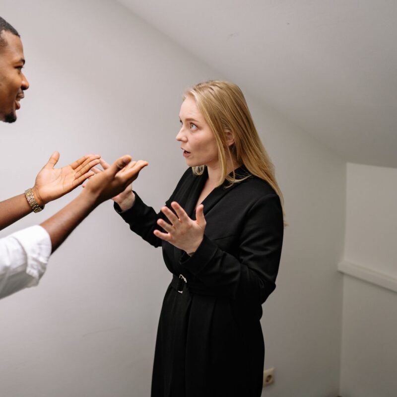 A man and woman having a heated discussion indoors