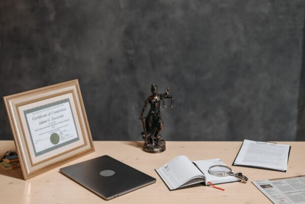 Legal documents and a laptop arranged on a lawyer’s desk