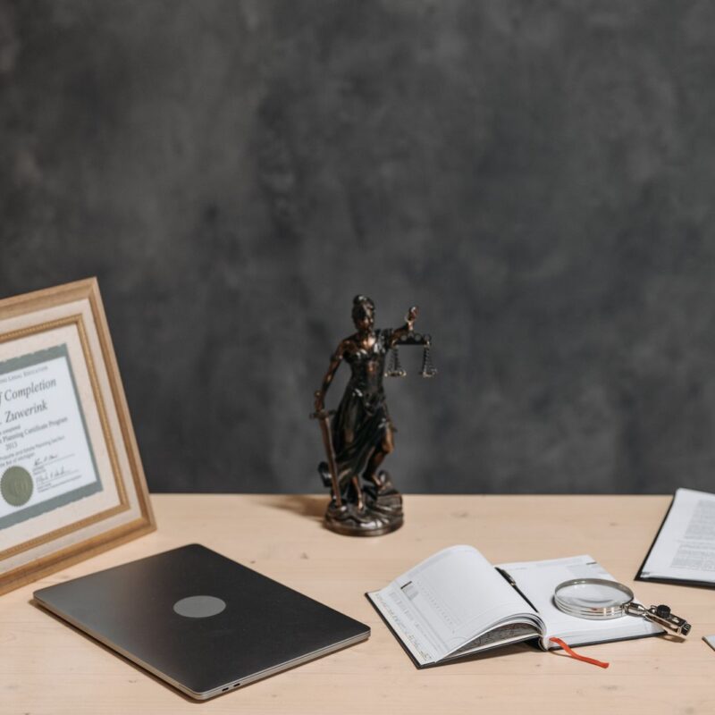 Legal documents and a laptop arranged on a lawyer’s desk